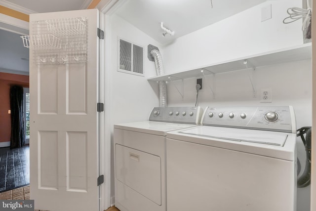 laundry room with laundry area, washing machine and dryer, and visible vents