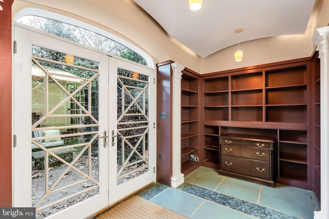 spacious closet with vaulted ceiling and decorative columns