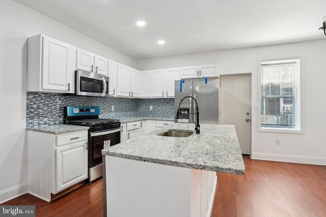 kitchen with white cabinetry, appliances with stainless steel finishes, dark wood-style flooring, and a sink