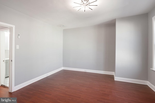 empty room with wood finished floors and baseboards