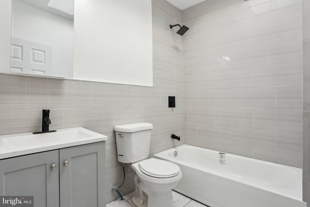 full bathroom with shower / bathing tub combination, vanity, toilet, and tile walls