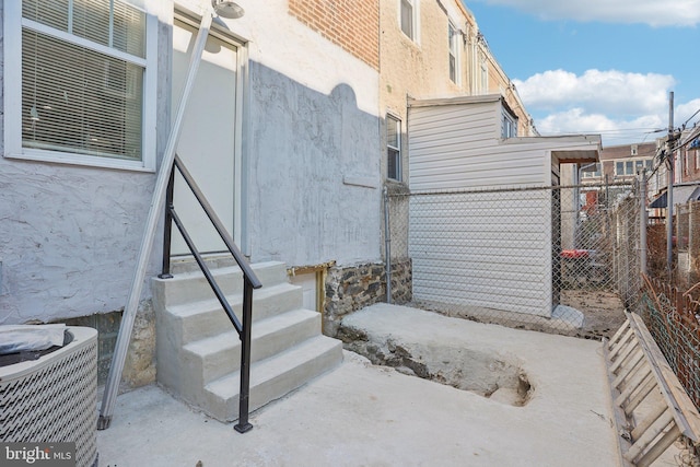 exterior space with fence and central air condition unit