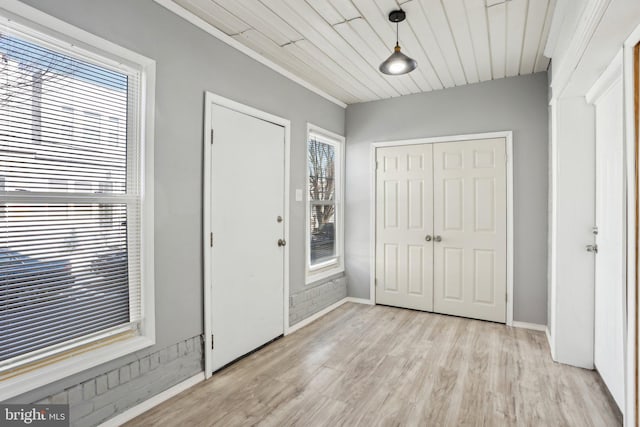 entrance foyer featuring baseboards and light wood finished floors