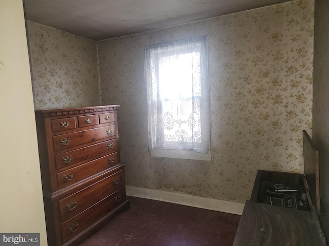 bedroom with baseboards and wallpapered walls