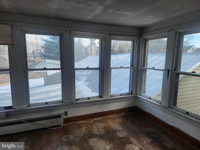 unfurnished sunroom with baseboard heating