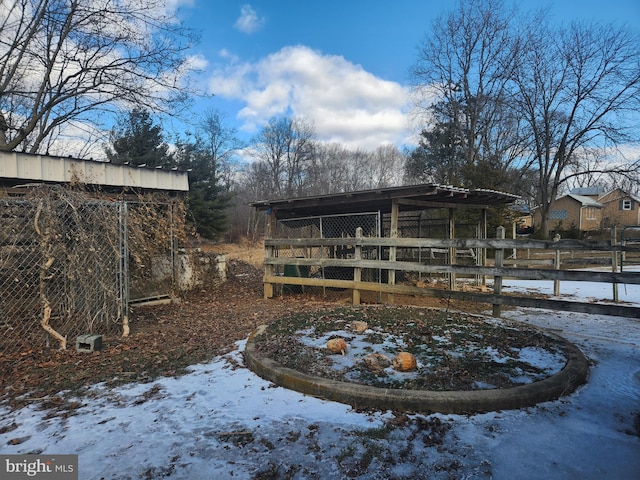 yard covered in snow with an outdoor structure