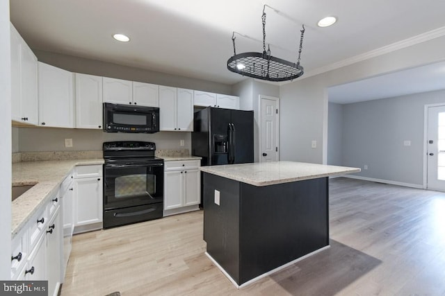 kitchen featuring light stone countertops, black appliances, white cabinets, and light wood finished floors