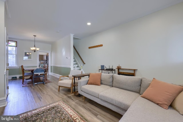 living room with baseboards, stairs, recessed lighting, light wood-style floors, and a notable chandelier