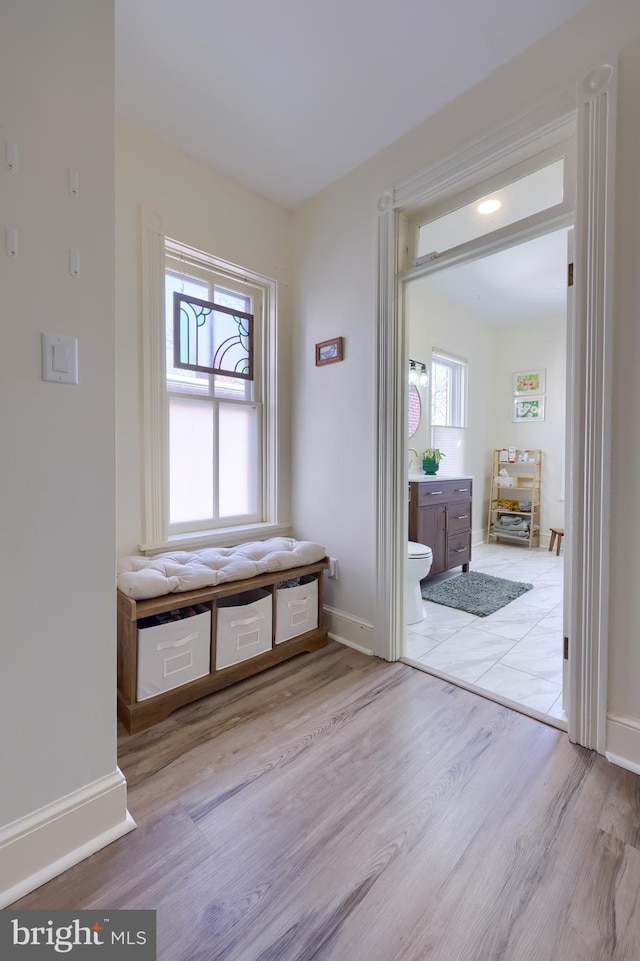 interior space featuring baseboards and wood finished floors