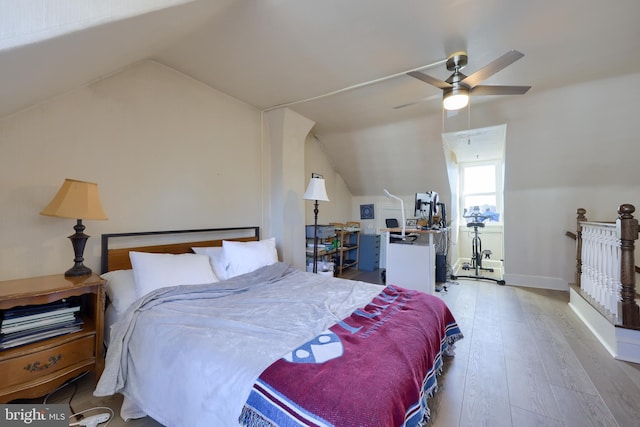 bedroom featuring lofted ceiling, a ceiling fan, and hardwood / wood-style flooring