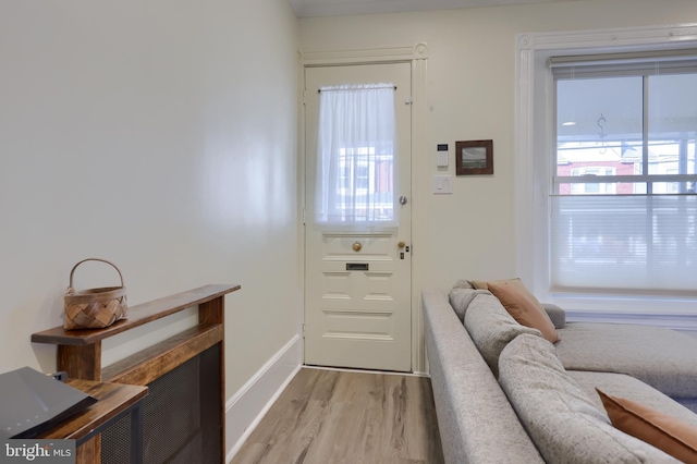 entryway featuring baseboards and wood finished floors