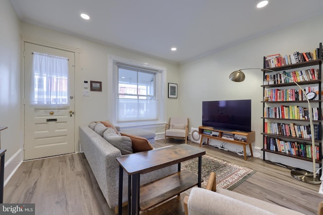 living area featuring recessed lighting, baseboards, and light wood finished floors