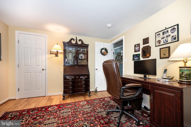 office area featuring baseboards and wood finished floors