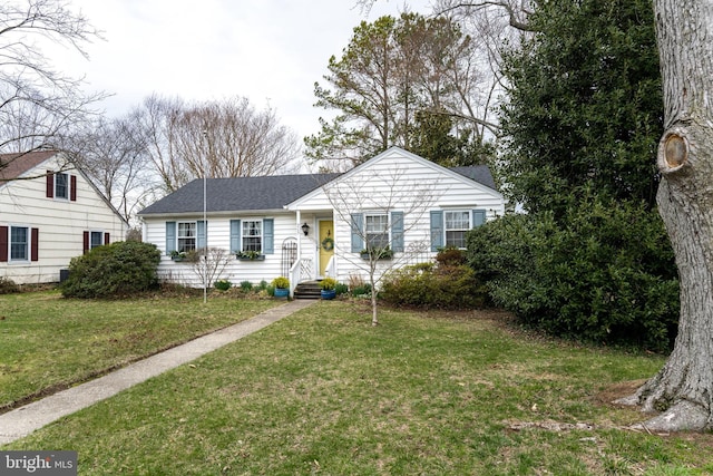 ranch-style home with a front lawn and a shingled roof