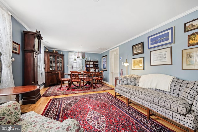 living room featuring ornamental molding, wood finished floors, and baseboards