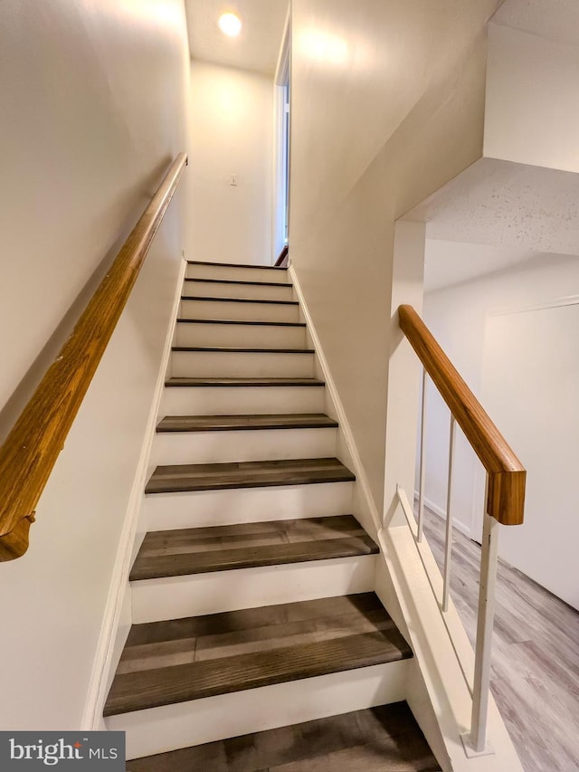 staircase featuring recessed lighting