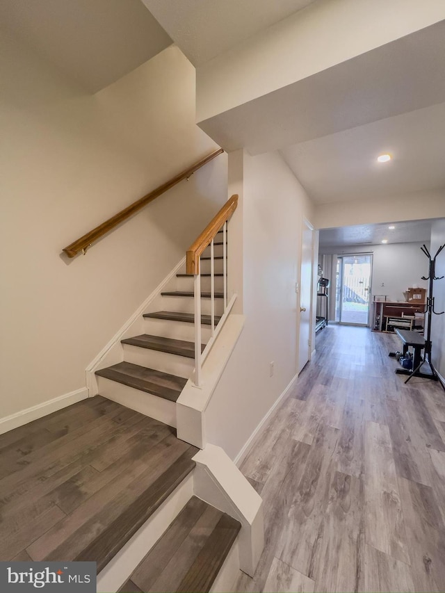 staircase with recessed lighting, baseboards, and wood finished floors