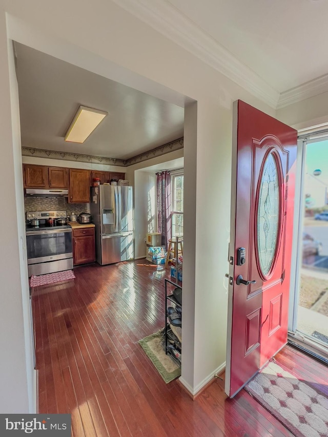 entryway with dark wood-style floors, baseboards, and ornamental molding