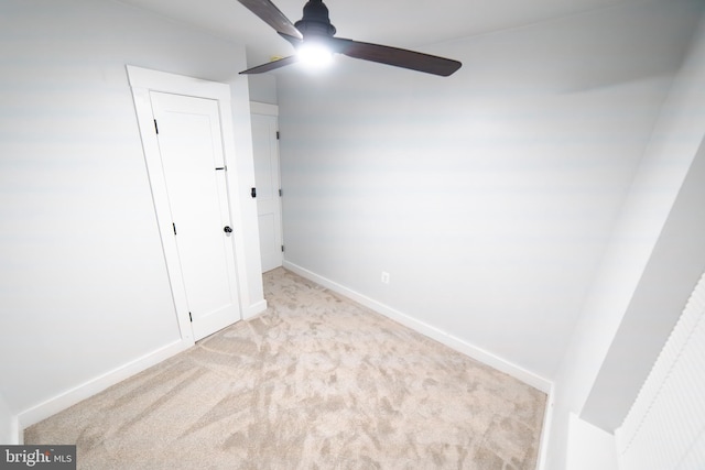 unfurnished bedroom with ceiling fan, carpet floors, and baseboards