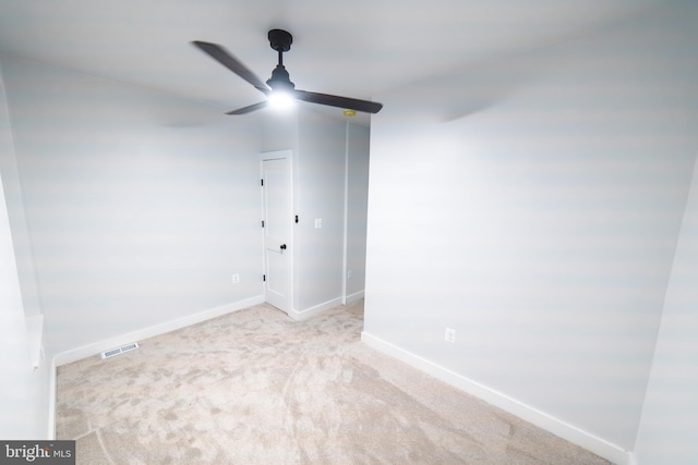 empty room featuring a ceiling fan, carpet, visible vents, and baseboards