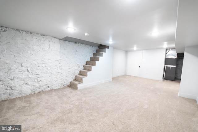 finished basement featuring carpet and stairway