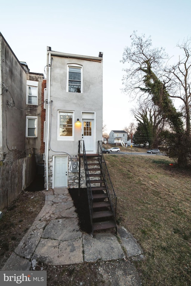 view of front of property featuring fence and stucco siding