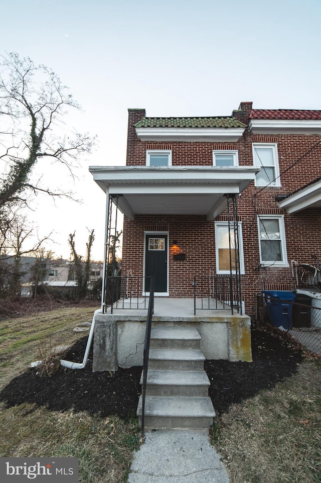 view of front facade with a porch and brick siding