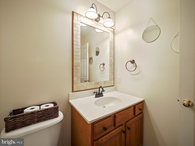 bathroom with toilet and vanity