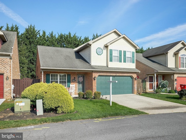 traditional-style house with a garage, brick siding, fence, concrete driveway, and a front yard