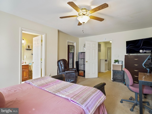 bedroom with light carpet, ceiling fan, and ensuite bathroom