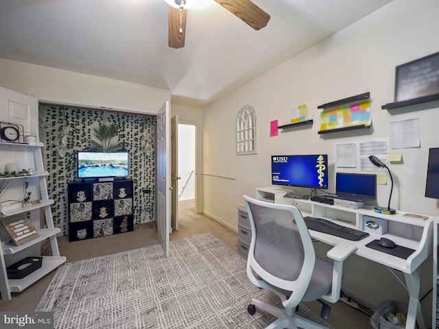 office with carpet floors and a ceiling fan