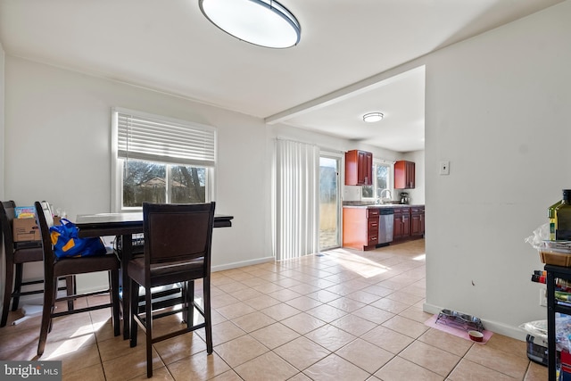 dining space featuring light tile patterned floors, a wealth of natural light, and baseboards