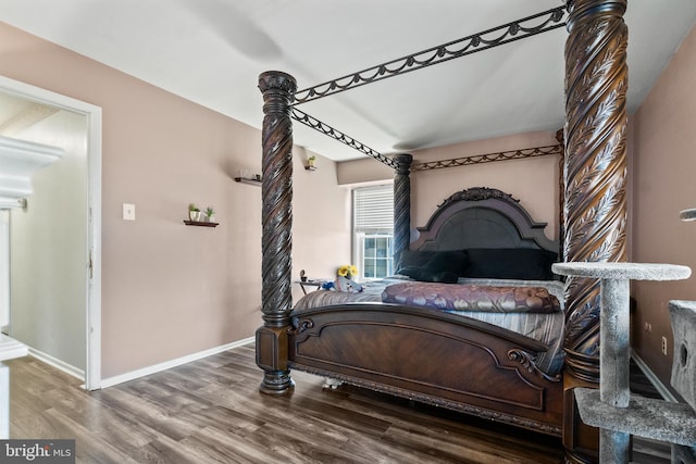 bedroom featuring baseboards and wood finished floors