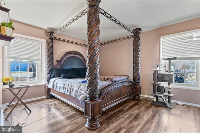 bedroom with baseboards and wood finished floors