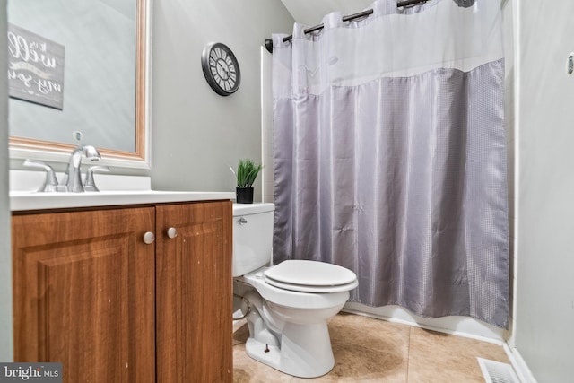 bathroom featuring toilet, vanity, visible vents, and tile patterned floors