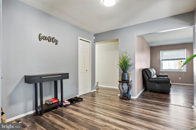 sitting room with baseboards and wood finished floors