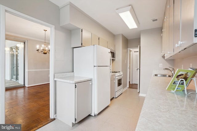 kitchen with light countertops, white appliances, a sink, and visible vents