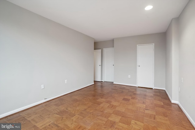 unfurnished room featuring recessed lighting and baseboards