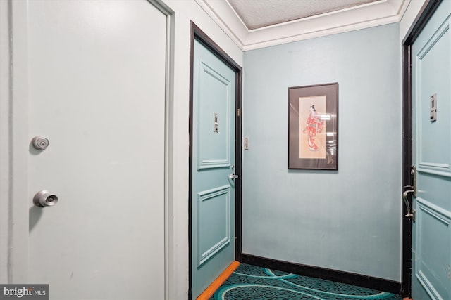 doorway featuring baseboards and a textured ceiling