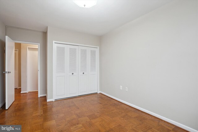 unfurnished bedroom featuring a closet and baseboards