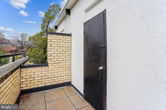 exterior space with a balcony and stucco siding