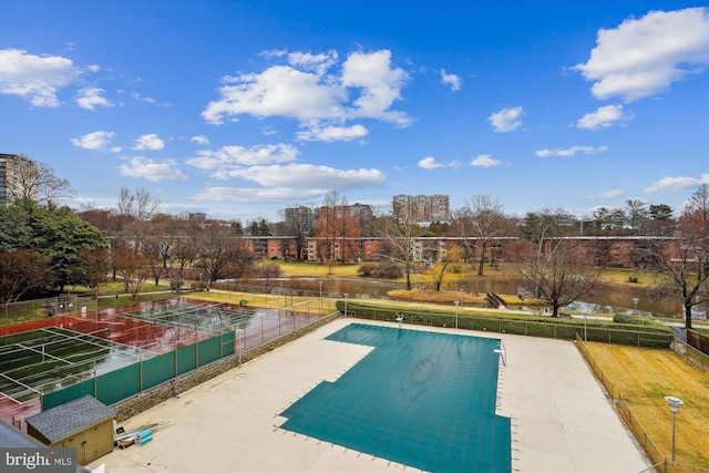 view of swimming pool featuring fence