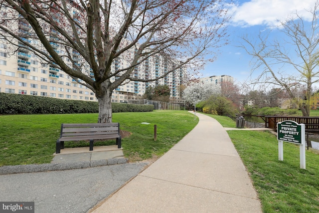 view of community with a yard and fence