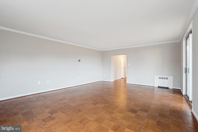 unfurnished room with radiator heating unit, baseboards, and crown molding