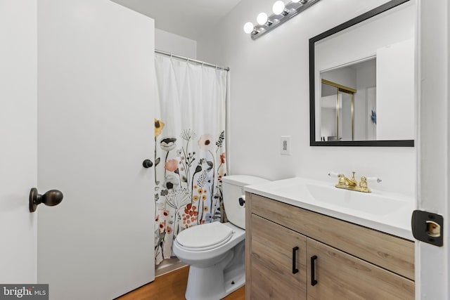 full bathroom featuring curtained shower, vanity, toilet, and wood finished floors