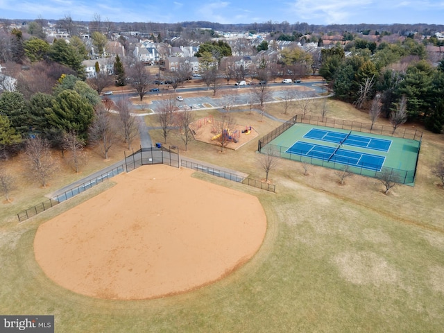 exterior space featuring a tennis court and fence