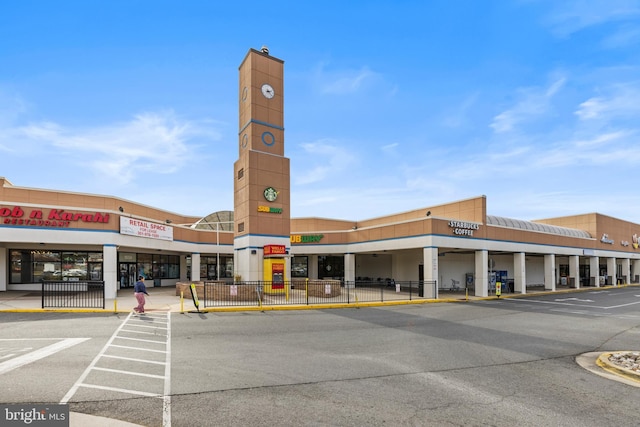 view of building exterior with uncovered parking