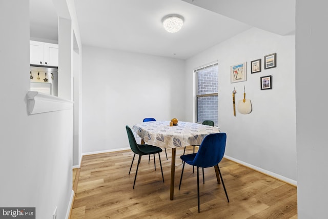 dining room featuring baseboards and light wood-style floors