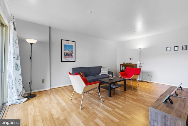 living room featuring wood finished floors and baseboards