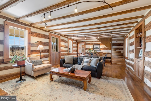 living area with beam ceiling and hardwood / wood-style flooring